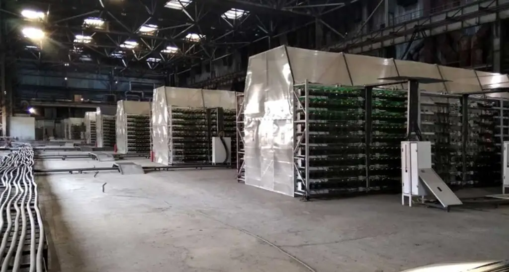 Miner hosting facility with miners and racks in Russia.