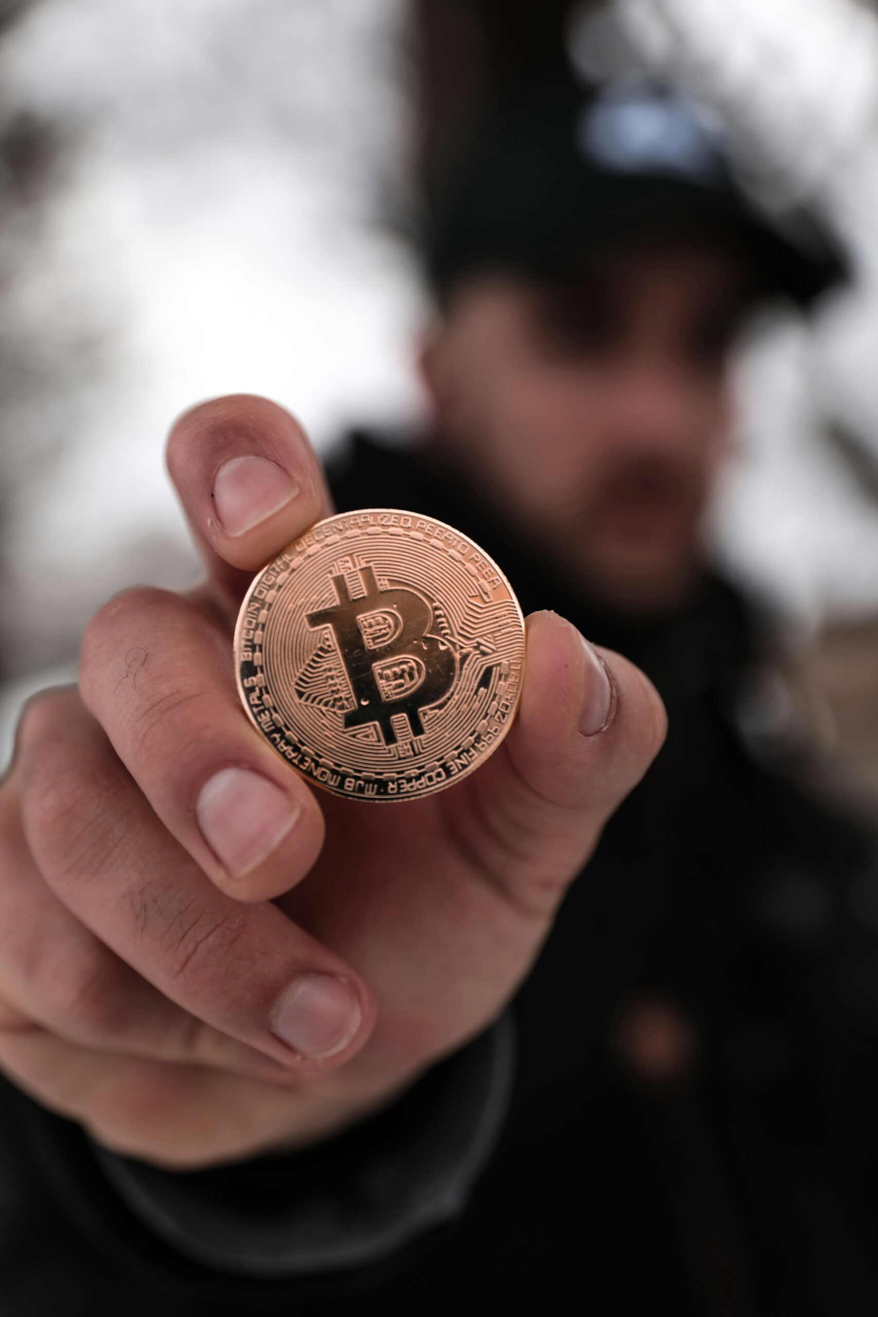 Person holding up Bitcoin