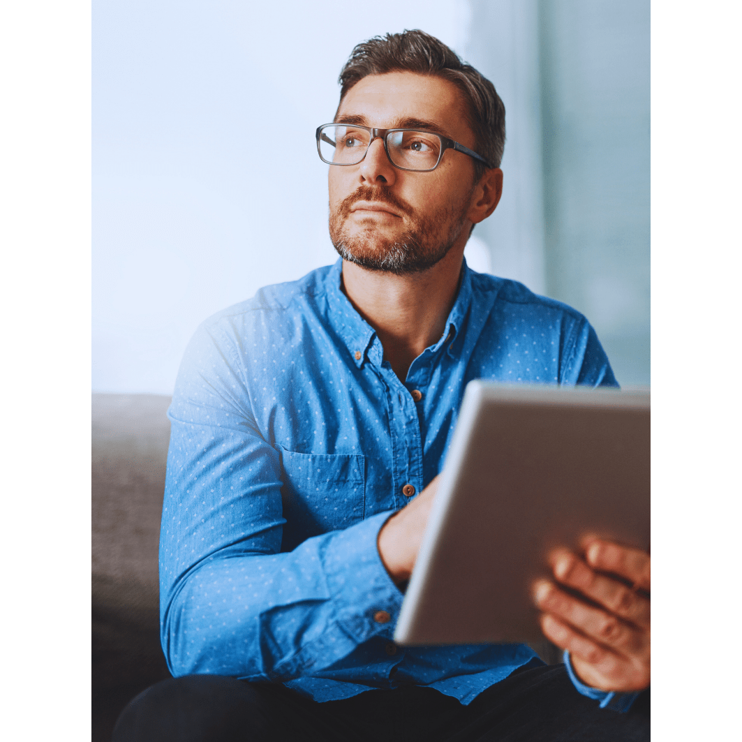 A man in glases holding a n ipad looking up anticipating the release of the antminer Z15 pro
